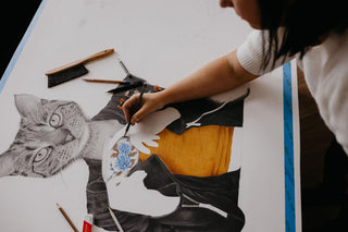 Artist Laura J Stratton working on her cat-lady artwork, Blissful Ignorance.