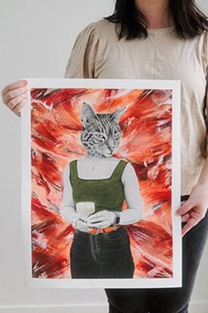 Person holding a fine art print of artwork titled Eternal Sunset. Artwork is of a person with a cat's face against a red abstract background.
