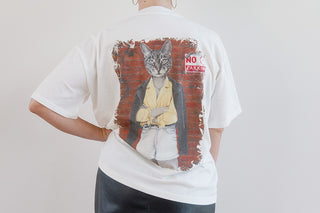 White unisex T-shirt featuring artwork from Laura J Stratton's "Before The Sky Turns Grey" design, displayed flat on a white background.