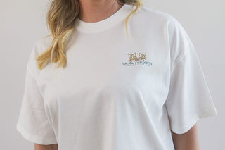 White T-shirt by Laura J Stratton featuring a front logo design inspired by "Before The Sky Turns Grey" artwork.