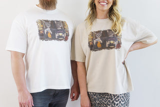 Front view of a Laura J Stratton Blissful Ignorance T-Shirt featuring a colorful cat lady art design.