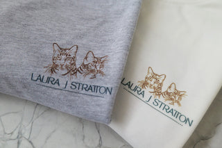Laura J Stratton "Before The Sky Turns Grey" T-shirt featuring a cat lady art logo on soft fabric.